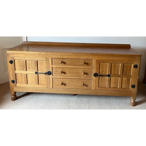 789 - A Robert 'Mouseman' Thompson sideboard with adzed top comprising two cupboards with 3 central drawer... 