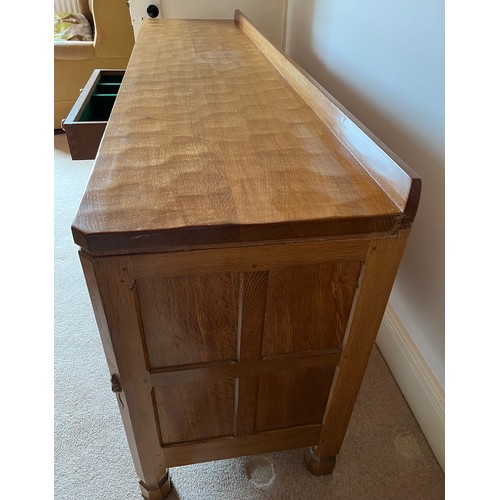 789 - A Robert 'Mouseman' Thompson sideboard with adzed top comprising two cupboards with 3 central drawer... 