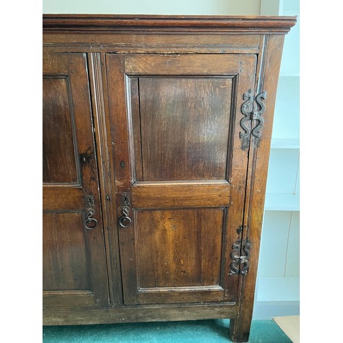 1303 - An 18th C Oak two door cupboard with shelved interior 127cm w x 42c d x 139cm h