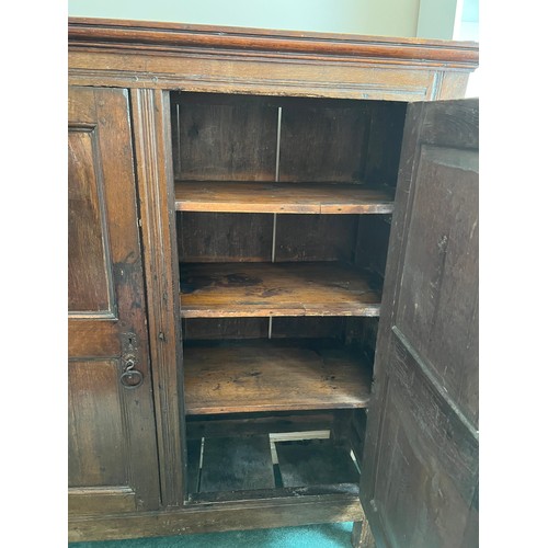 1303 - An 18th C Oak two door cupboard with shelved interior 127cm w x 42c d x 139cm h