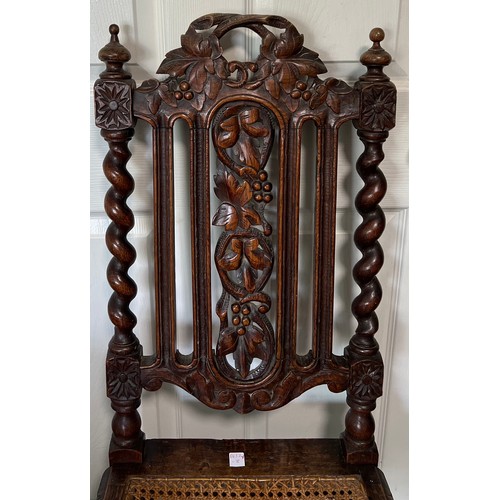 1310 - A carved oak single chair with cane seat