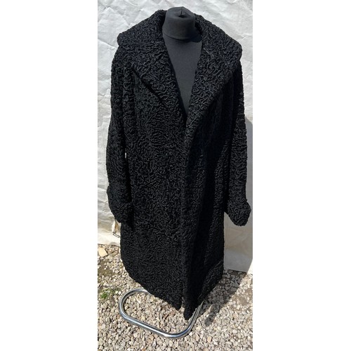 509 - A vintage curly Persian lamb coat. 56cm under arm to arm.