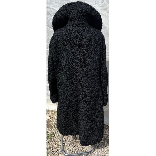 509 - A vintage curly Persian lamb coat. 56cm under arm to arm.