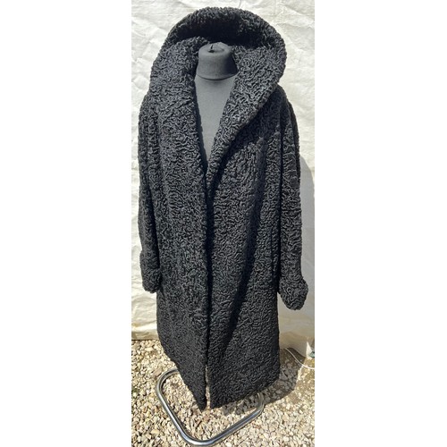 509 - A vintage curly Persian lamb coat. 56cm under arm to arm.