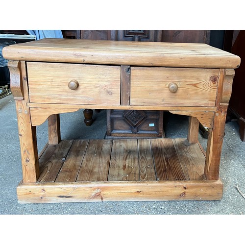 1328 - A pine 2 drawer side table. 113 w x 54 d x 86cm h.