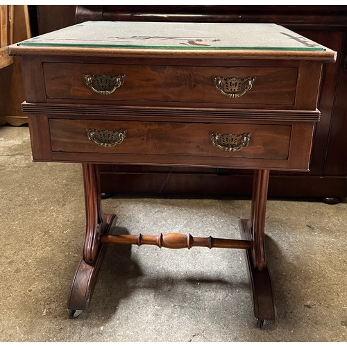 1332 - A mahogany 2 drawer side table on castors with decorative side supports and brass columns. 67 w x 55... 