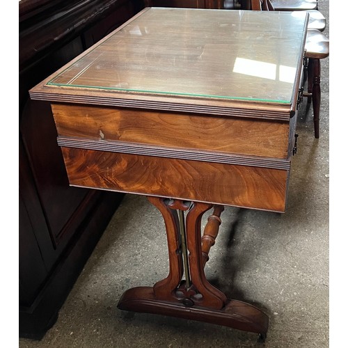 1332 - A mahogany 2 drawer side table on castors with decorative side supports and brass columns. 67 w x 55... 