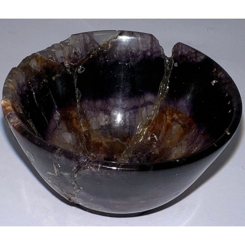 327 - A small turned Blue John bowl, raised on a slight foot. 4.7cm w.