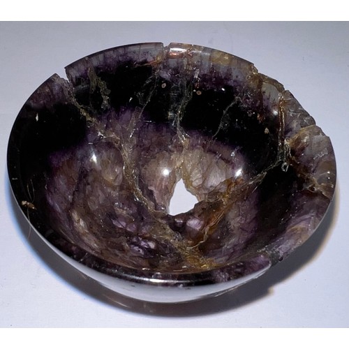 327 - A small turned Blue John bowl, raised on a slight foot. 4.7cm w.