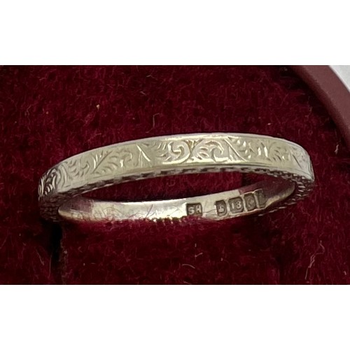 398 - An 18ct white gold wedding band with engraved decoration. Size N. 3.1gm.