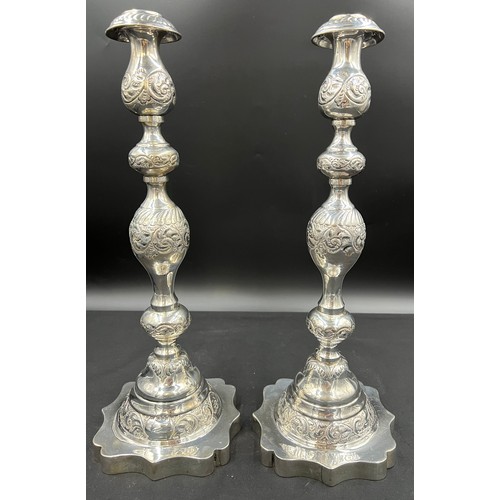 614 - A pair of silver Jewish Sabbath candlesticks, London 1929 with detachable sconces, engraved and chas... 