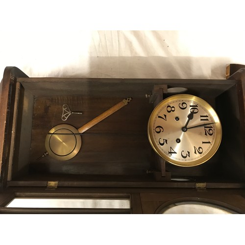 831 - Mahogany wall mounted clock measuring approx 81cms in length 34cms wide and 18cms deep believed to b... 