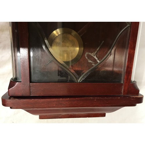 832 - Mahogany wall mounted clock with roman numerals on clock face. Believed to be working order, winds u... 