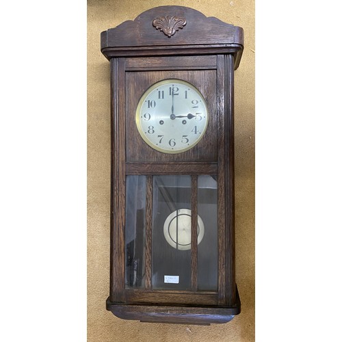 825 - Oak wall mounted clock max height 78cms x max  width 35cms x max depth 16.5cms.