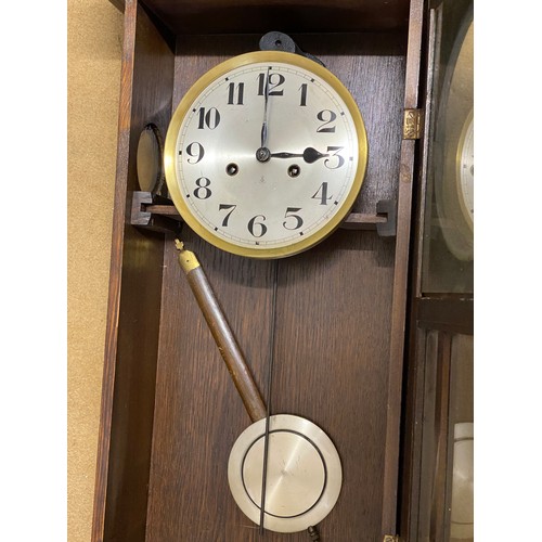 825 - Oak wall mounted clock max height 78cms x max  width 35cms x max depth 16.5cms.