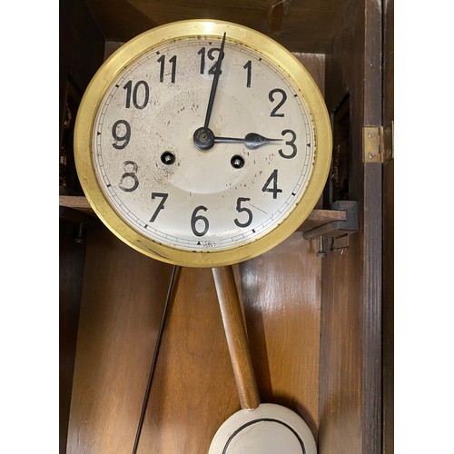 840 - An oak cased wall clock. 80cm h.