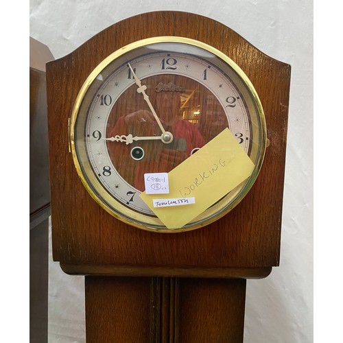 824 - Two wooden grandmother clocks believed to be in working order both 140cms high x 18cms deep one 27cm... 