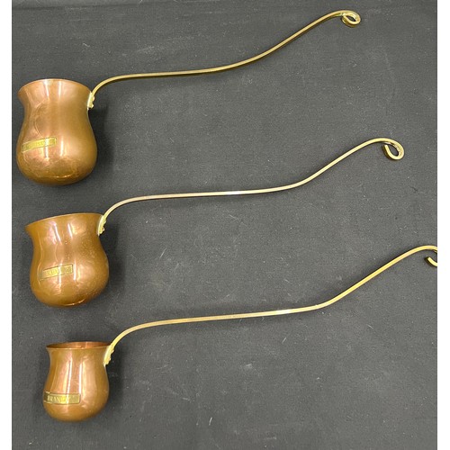 849A - A set of three graduated copper and brass toddy ladles engraved 'Whisky', 'Rum' and 'Brandy'. Larges... 