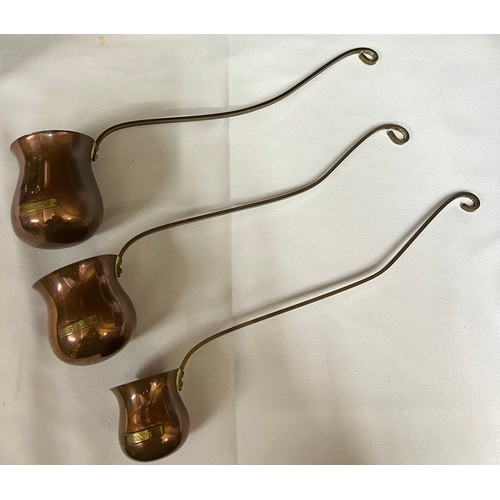 849A - A set of three graduated copper and brass toddy ladles engraved 'Whisky', 'Rum' and 'Brandy'. Larges... 