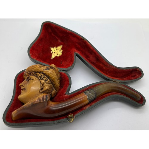 851A - A well patinated meerschaum pipe with figural female head, amber mouth piece and hallmarked engraved... 