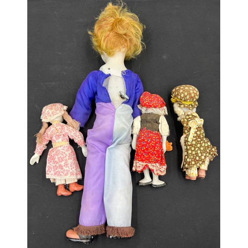 665A - Four bisque headed dolls including a wind up musical clown 50cm h.