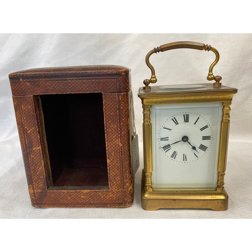 802 - A brass carriage clock with Swiss movement. 14cms h with handle up. Key included. Winds and goes. In... 