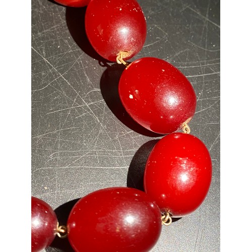 378 - A quantity of cherry amber beads to include 2 necklaces and other loose beads. 164gm total weight.