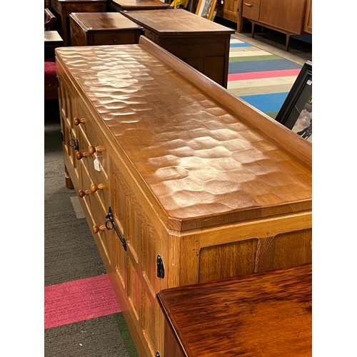 789 - A Robert 'Mouseman' Thompson sideboard with adzed top comprising two cupboards with 3 central drawer... 