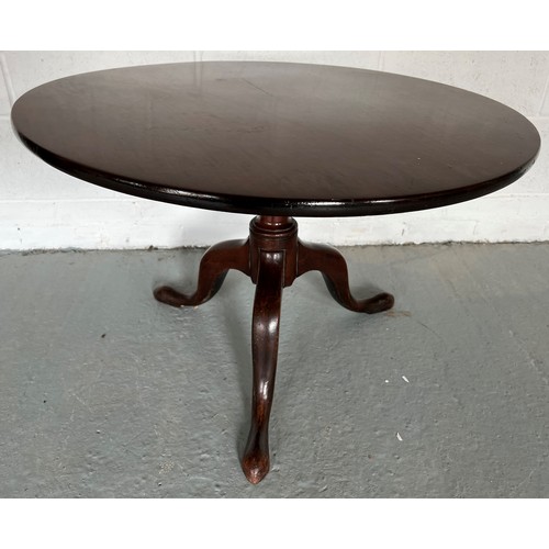 174 - A tilt top mahogany table. 83cm d.