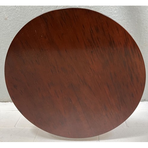 174 - A tilt top mahogany table. 83cm d.