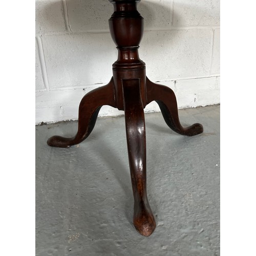 174 - A tilt top mahogany table. 83cm d.