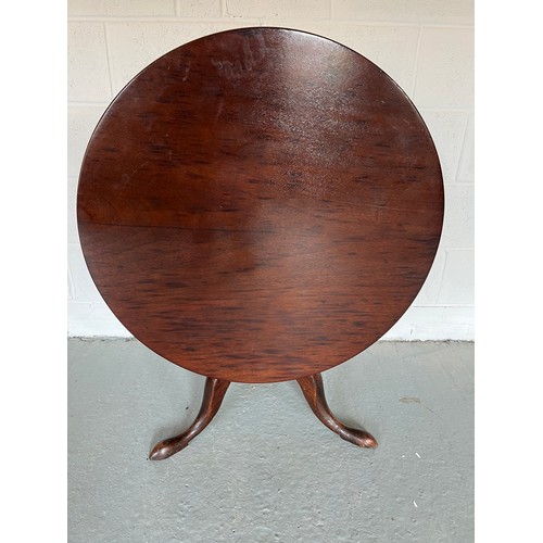 174 - A tilt top mahogany table. 83cm d.