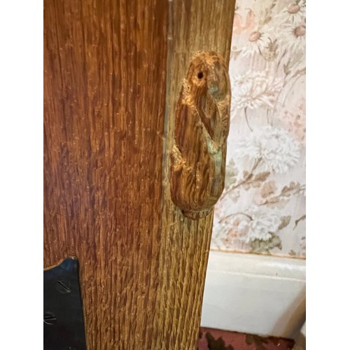 175 - Peter Heap Rabbitman, An Oak Panelled Sideboard, with raised upstand above two cupboard doors enclos... 