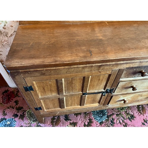 175 - Peter Heap Rabbitman, An Oak Panelled Sideboard, with raised upstand above two cupboard doors enclos... 