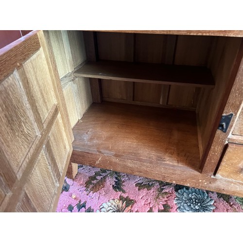 175 - Peter Heap Rabbitman, An Oak Panelled Sideboard, with raised upstand above two cupboard doors enclos... 