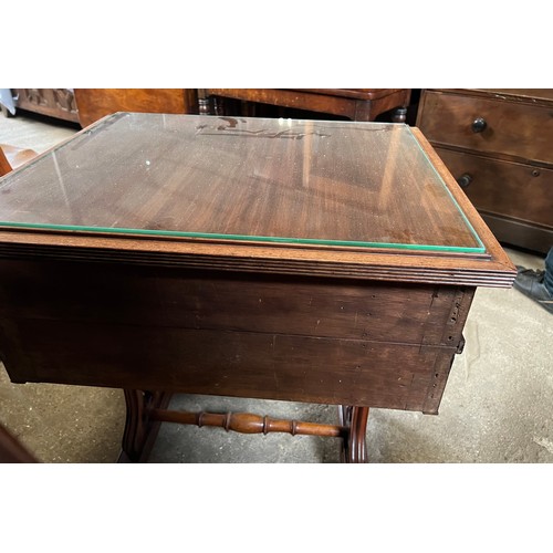 165 - A mahogany 2 drawer side table on castors with decorative side supports and brass columns. 67 w x 55... 