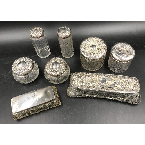 862 - Eight silver topped containers, two with cartouche. Largest 17 x 7 x 5cm h.