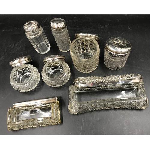 862 - Eight silver topped containers, two with cartouche. Largest 17 x 7 x 5cm h.