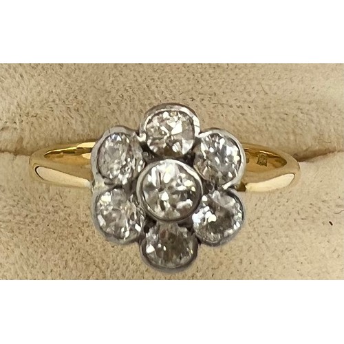 635 - An 18ct gold ring set with diamonds to form a six petalled flower. Size N. Weight 3.2gm.