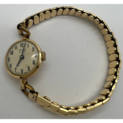 923 - A 9ct gold Timor ladies wristwatch on expanding rolled gold bracelet. Winds and ticks.