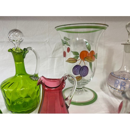 476 - A selection of coloured and hand painted glass ware to include: 3 x cranberry jugs, 3 x green jugs a... 