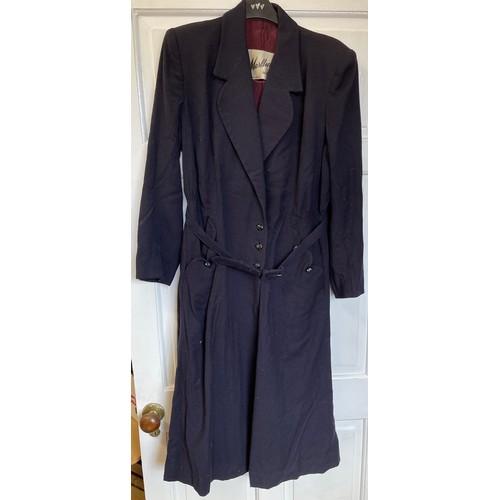 730 - Three vintage clothing items to include a navy long belted coat by Marlbeck Model, blue cotton smock... 