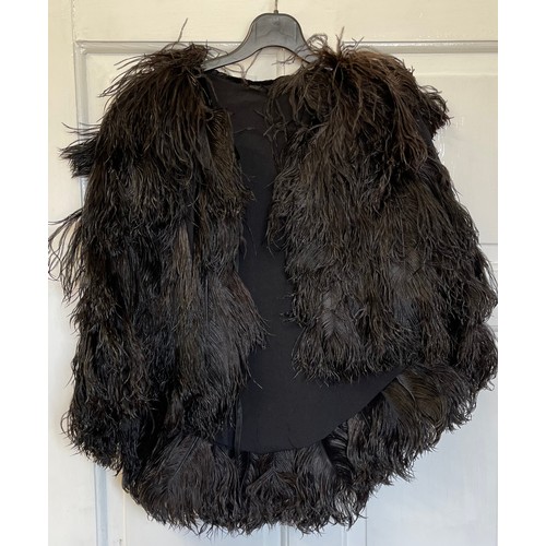 733 - Five capes to include a black Ostrich feather cape and a white Ostrich feather cape and 3 x fur cape... 