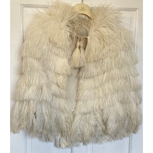 733 - Five capes to include a black Ostrich feather cape and a white Ostrich feather cape and 3 x fur cape... 