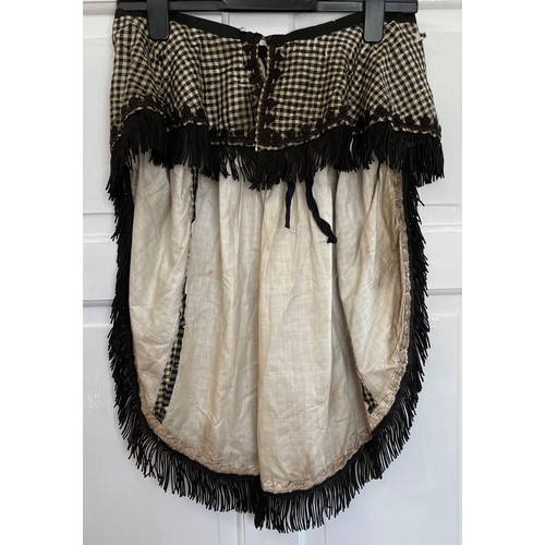 735 - A black Victorian long overskirt with black and white checked silk apron pinny together with a small... 