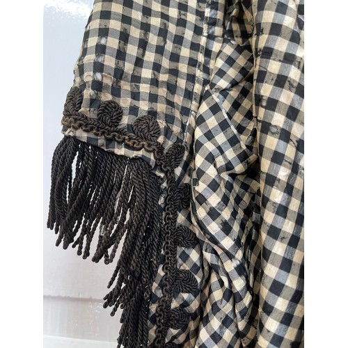 735 - A black Victorian long overskirt with black and white checked silk apron pinny together with a small... 