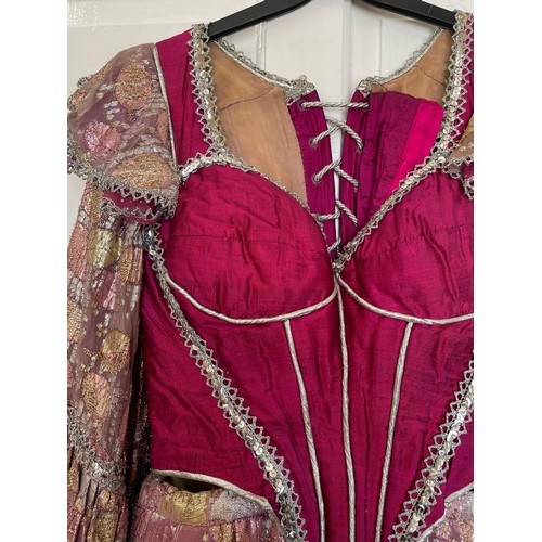 740 - A pink coloured stage costume dress with corset top and long loose sleeve together with a separate l... 