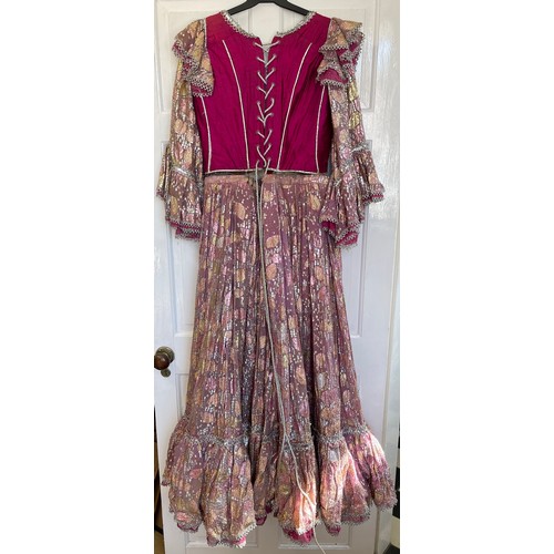 740 - A pink coloured stage costume dress with corset top and long loose sleeve together with a separate l... 