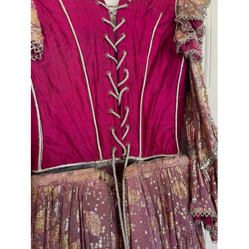 740 - A pink coloured stage costume dress with corset top and long loose sleeve together with a separate l... 