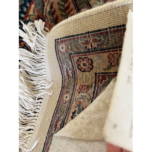 1125 - A vintage Oriental good quality rug in shades of red, blue and cream. 268 x 170cm w.
